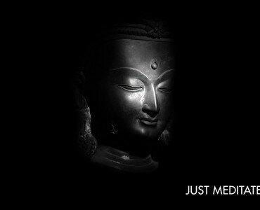 Serene black-and-white Buddha head with closed eyes and white JUST MEDITATE text at the bottom